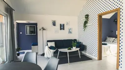 a living room with a couch and a table at Tulichatki domki całoroczne in Tarnawa Dolna