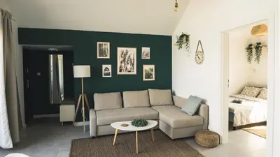 a living room with a couch and a table at Tulichatki domki całoroczne in Tarnawa Dolna