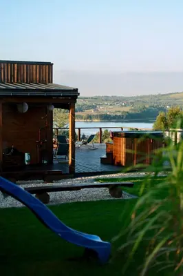 a house with a view of the water at Tulichatki domki całoroczne in Tarnawa Dolna