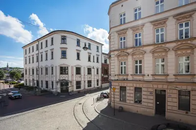 two buildings next to each other on a street at City of the Kings - Old Depot Apartment in Kraków