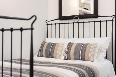 a black bed with two pillows on it at City of the Kings - Old Depot Apartment in Kraków