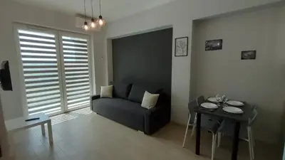 a living room with a couch and a table at Apartament KoraZone 2 ZATOR in Zator
