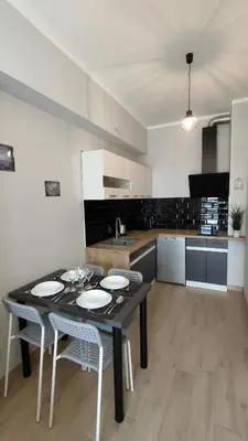 a kitchen with a table and chairs in a room at Apartament KoraZone 2 ZATOR in Zator