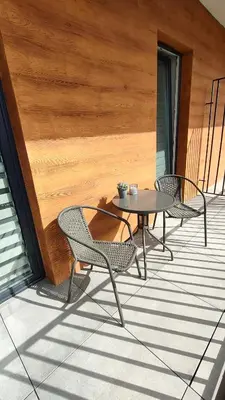 two chairs and a table on a patio at Apartament KoraZone 2 ZATOR in Zator
