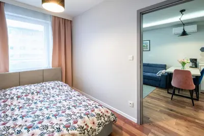 a bedroom with a bed and a window and a desk at Republiki in Kraków