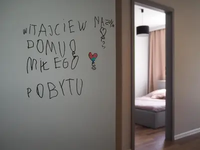 a room with a mirror with writing on the wall at Republiki in Kraków