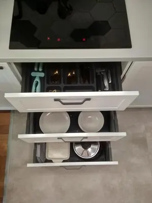 an open drawer in a kitchen with a tv at Republiki in Kraków