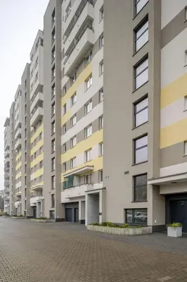 an empty street in front of apartment buildings at Republiki in Kraków