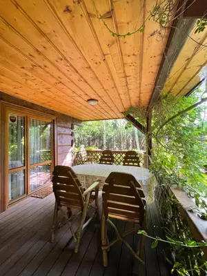 a wooden deck with a table and chairs on it at Dom z bali przy szlaku in Kasina Wielka