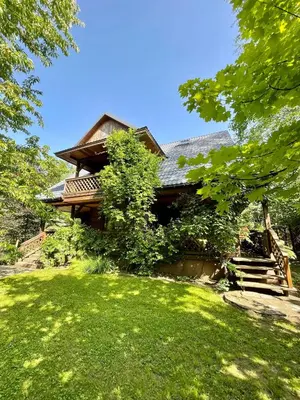 a house with a green lawn in front of it at Dom z bali przy szlaku in Kasina Wielka