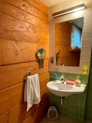 a bathroom with a sink and a mirror at Dom z bali przy szlaku in Kasina Wielka