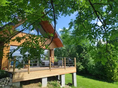 a house on a hill with a green field at Przystanek Gorce in Nowy Targ