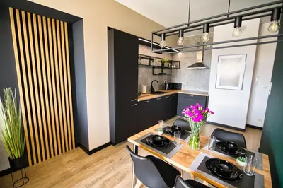 a kitchen with a table and chairs in a room at Apartament Proste Chwile 38 by Housine in Zator