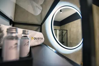 a bathroom with a mirror and two bottles on a counter at Apartament Proste Chwile 38 by Housine in Zator