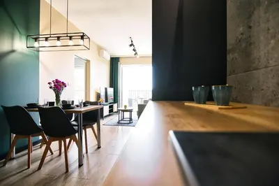 a dining room with a table and chairs at Apartament Proste Chwile 38 by Housine in Zator
