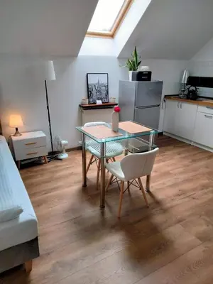 a kitchen with a table and chairs in a room at Urokliwy Zakątek to apartament tylko dla Państwa in Osiek