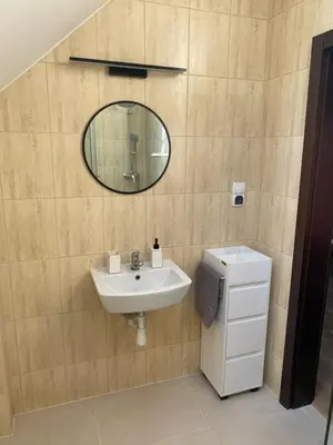 a bathroom with a sink and a mirror at Urokliwy Zakątek to apartament tylko dla Państwa in Osiek