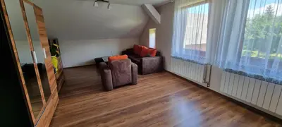 a living room with two chairs and a window at Prywatny pokój z kuchnią i łazienką in Mszana Dolna