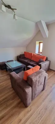 a living room with two couches and a table at Prywatny pokój z kuchnią i łazienką in Mszana Dolna