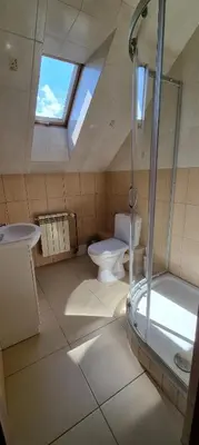a bathroom with a shower and a toilet and a sink at Prywatny pokój z kuchnią i łazienką in Mszana Dolna