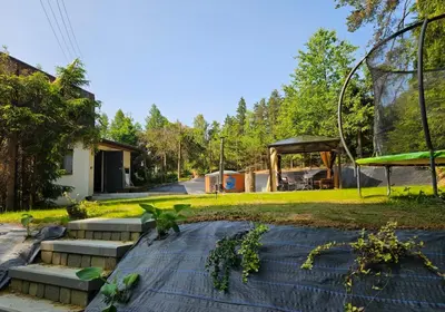 a garden with stairs and a gazebo at Leśne zacisze - dom z kominkiem i balią in Jordanów