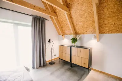 a bedroom with a bed and a dresser at Apartamenty Na Potokach in Żegocina
