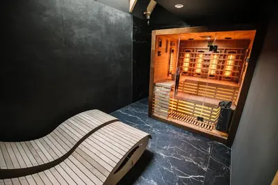 a bench in a room with a wine cellar at Apartamenty Na Potokach in Żegocina