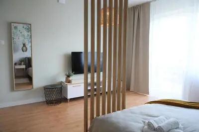 a bedroom with a bed and a television in it at Złota#208 in Złota