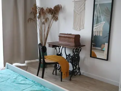 a bedroom with a table and a chair with a piano at Złota#208 in Złota