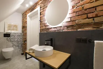 a bathroom with a white sink and a brick wall at Złota#208 in Złota