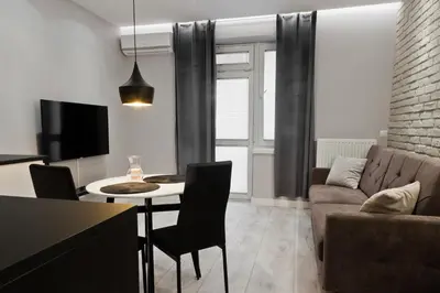 a living room with a couch and a table at Apartament Nowa Huta in Kraków