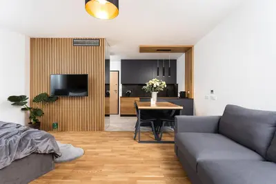 a living room with a couch and a table at InPoint Apartments G15 near Old Town & Kazimierz District & Optional Paid Parking in Kraków