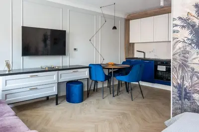 a living room with a large screen in the wall at InPoint Apartments G15 near Old Town & Kazimierz District & Optional Paid Parking in Kraków