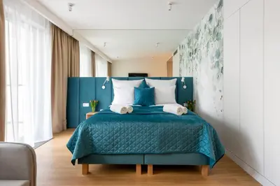 a bedroom with a bed and a table and a dining room at InPoint Apartments G15 near Old Town & Kazimierz District & Optional Paid Parking in Kraków