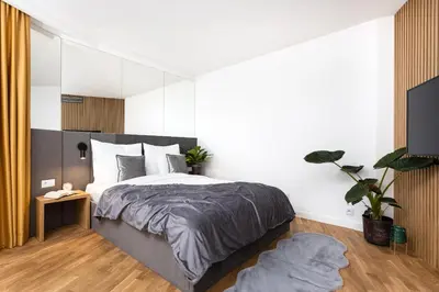 a bathroom with a washing machine and a sink at InPoint Apartments G15 near Old Town & Kazimierz District & Optional Paid Parking in Kraków