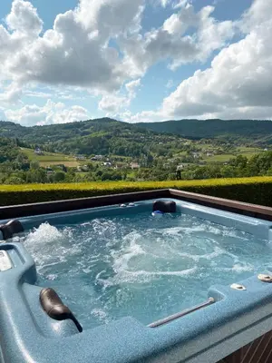 a hot tub with a view of a vineyard at Urlopowa Chata in Targanice