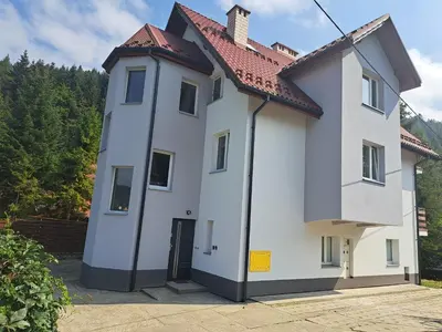 a white house with a red roof at Apartament Koninki in Koninki