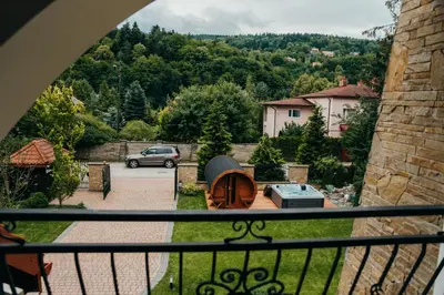 a view from a balcony of a yard with a car at Zarabie Residence in Myślenice