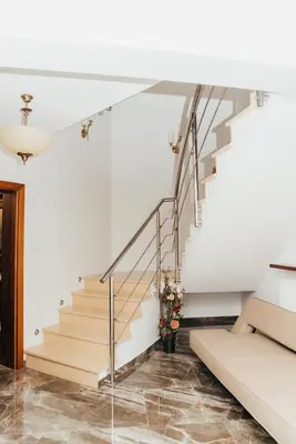 a staircase in a home with white walls and concrete floors at Zarabie Residence in Myślenice