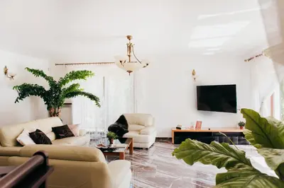 a living room with two couches and a tv at Zarabie Residence in Myślenice