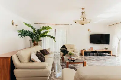 a living room with a couch and a tv at Zarabie Residence in Myślenice
