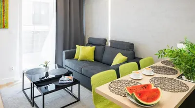 a living room with a couch and a table with fruits on it at Rakowicka Apartments with tarrace, AC and free parking in Kraków