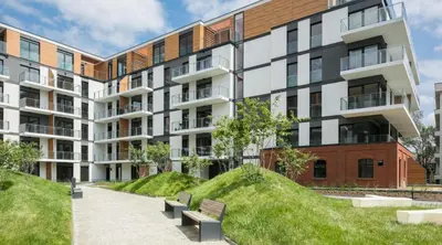 an apartment building with benches in front of it at Rakowicka Apartments with tarrace, AC and free parking in Kraków