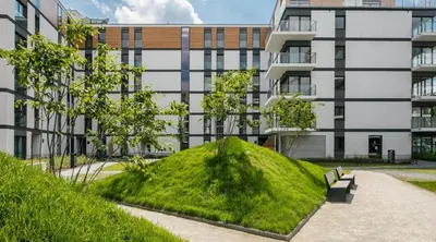 a mound of grass in front of a building at Rakowicka Apartments with tarrace, AC and free parking in Kraków