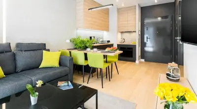 a living room with a couch and a table at Rakowicka Apartments with tarrace, AC and free parking in Kraków