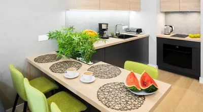 a kitchen with a table with watermelons on it at Rakowicka Apartments with tarrace, AC and free parking in Kraków
