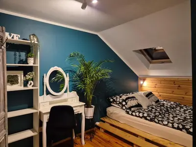 a bedroom with a bed and a desk and a mirror at Apartament u Agaty Czernichów Kraków Zator in Czernichów