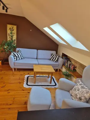 a living room with a blue couch and a table at Apartament u Agaty Czernichów Kraków Zator in Czernichów