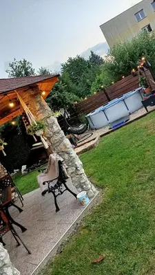 a stone wall with a bench in a yard at Apartament u Agaty Czernichów Kraków Zator in Czernichów
