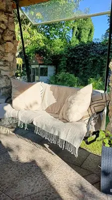 a porch swing with pillows on a patio at Apartament u Agaty Czernichów Kraków Zator in Czernichów